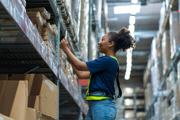 African American female employees Put on the uniform, hold the tablet, inspect the goods, place...