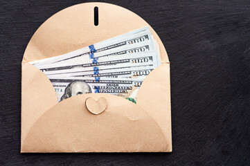 money in a paper envelope, cash, money, black background, us dollars, place for text