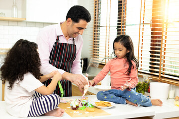 Group of four Diverse Family, Asian and Arab Preschool African Arab kid person make Cake cooking in...
