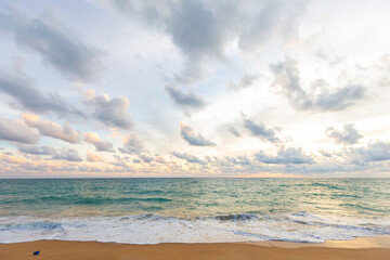 Fototapeta na wymiar Idyllic sunset sky with cloud on sea beach sand wave