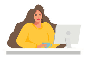 A beautiful and happy woman sitting at a computer and working.