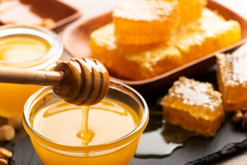 Honey on wooden honey-dipper closeup food background