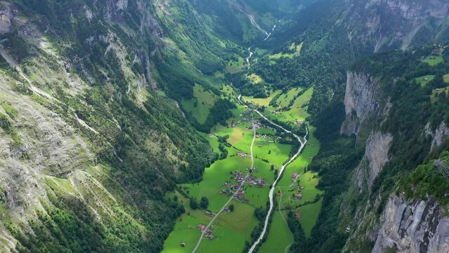 Lauterbrunnen valley with famous church and Staubbach waterfall. Lauterbrunnen village, Berner Oberland, Switzerland, Europe. Spectacular view of Lauterbrunnen valley in a sunny day, Switzerland.
