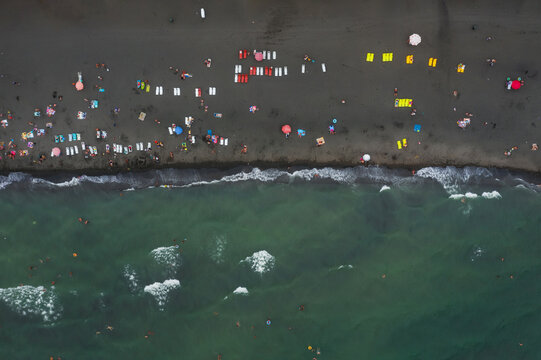 black beach in ureki village in georgia. a beach with magnetic sand where people rest and are treated. beach with inflatable entertainment in georgia. healing beach with black volcanic sand in Batumi