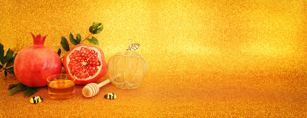 Rosh hashanah (jewish New Year holiday) concept. Taditional symbols over gold glitter background