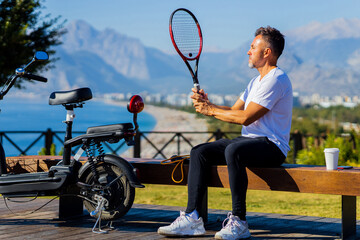 old-aged man good loking outdoors with eco scooter enjoying vacation