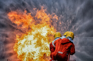 In Industry safety fire fighter team department on  training fight with gas and oil fire by hold...
