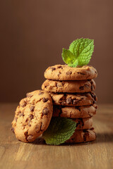 Chocolate cookies with mint on a wooden table.