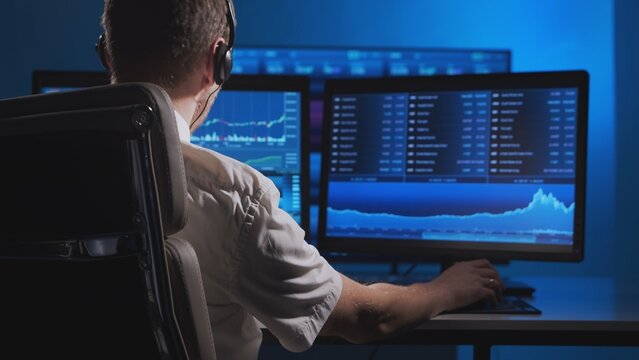 Broker works in office using workstation and analysis technology. Workplace of professional trader. Global financial markets, business strategy, currency exchange and banking.