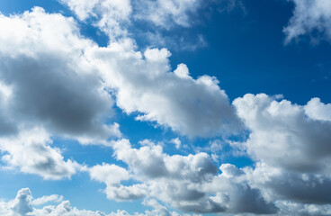 Clear blue sky and white clouds. Air clouds in the blue sky. Beautiful white cloud on clear blue sky as nature concept. Abstract style for text, design, pattern, background