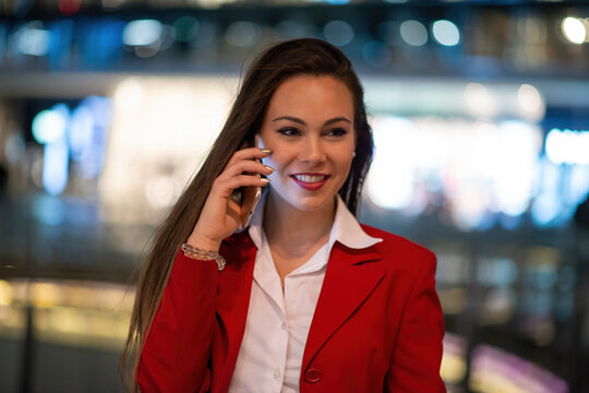 Businesswoman talking on her phone at night