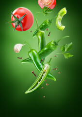 peppers with tomatoes in group flying on air stream on dark green background