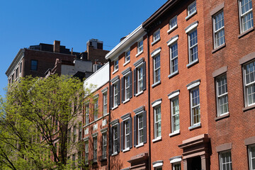 Fototapeta na wymiar Row of Old Colorful Brick Residential Buildings along a Street in Greenwich Village of New York City