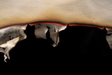 burning paper, glowing edge of paper on a black background