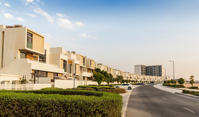 Fototapeta na wymiar Dubai, UAE - 08.16.2022 - Close up shot of a f modern townhouses in Dubai South district. City