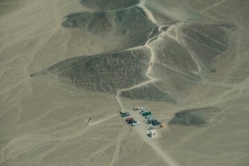Beautiful shot of cars in Nazca Condor Lines Geoglyphs in the Nasca desert