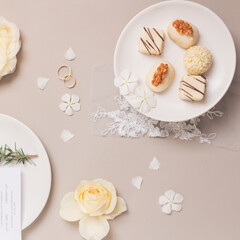Fototapeta na wymiar Gourmet candies. Spring composition on grey background. Wedding reception concept.
