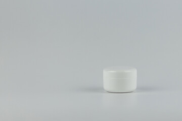 Skincare and cosmetology mockup with copy space. Unbranded white plastic jar for cosmetics products. Branding identity template for text and design