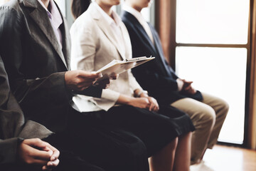 Graduate students holding resume are waiting for an interview job