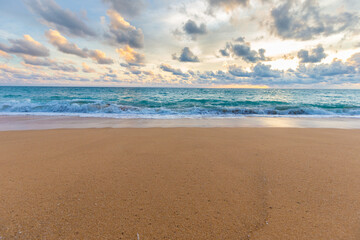 Fototapeta na wymiar Idyllic sunset sky with cloud on sea beach sand wave