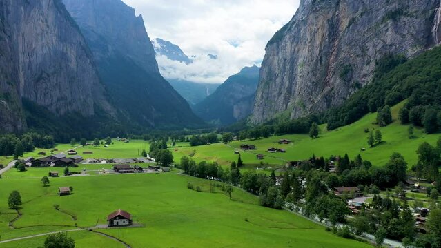 Lauterbrunnen valley with famous church and Staubbach waterfall. Lauterbrunnen village, Berner Oberland, Switzerland, Europe. Spectacular view of Lauterbrunnen valley in a sunny day, Switzerland.