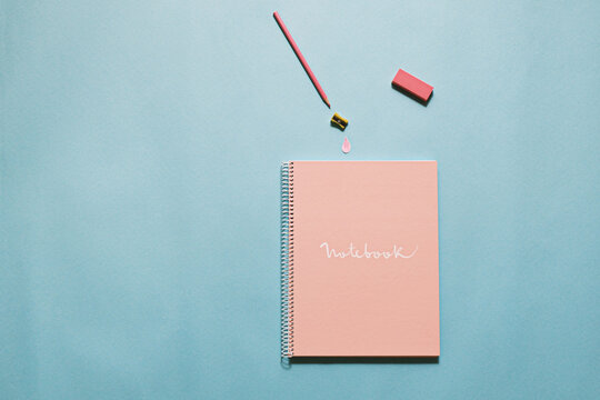 Notebook and school supplies: pencil, sharpener and eraser