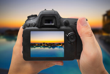 DSLR digital camera in hand, travel photo