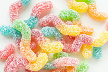 Colorful tasty jelly candies on a white background, top view.