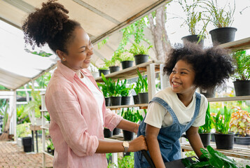 herb, kindergarten, growth, kid, afro, african, summer, flower, choosing, global warming concept, greenhouse, american, garden, centre, plant, shop, tree, woman, cart, mother, people, daughter, child,