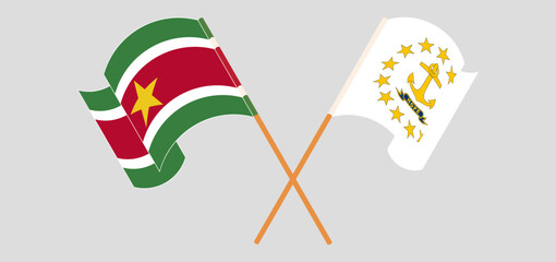 Crossed and waving flags of Suriname and the State of Rhode Island
