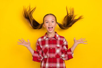 Photo of excited funny schoolkid dressed plaid shirt rising arms air wind blowing fly isolated...