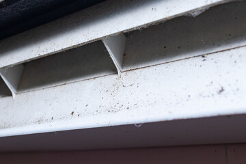 Dust and dirt stains are attached to the fins to control the wind direction of the air conditioner system.