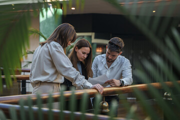 Shot of three businesspeople with documents planning their strategy in cozy office.