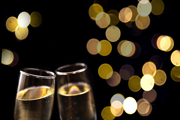 Two glasses of champagne on black background. © mariiaplo