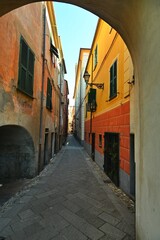Fototapeta na wymiar Colorful glimpse of ancient narrow streets Carrugi typical of Ligurian Riviera towns