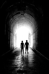 Two People Holding Hands Silhouette at Tunnel Love and Together