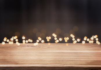 Christmas background with defocused lights and dark empty wood table. Mockup for product display