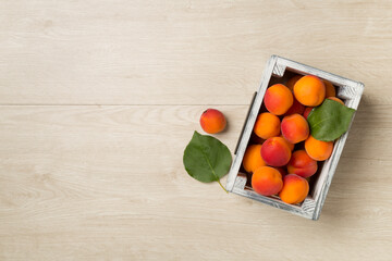 Composition with ripe apricots on wooden background, top view