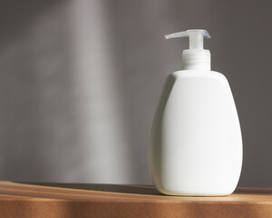 Minimal background for branding and product presentation. Cosmetic bottle on gray background.