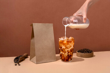 Coffee identity branding mockup. Blank brown craft bag with coffee beans and cup of coffee. Package mockup template for logo, brand, sticker, label.