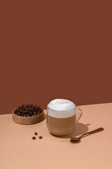 Hot coffee latte on brown table with copy space for your text. Close up hot cappuccino coffee cup.