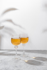 Two glasses of white wine on light background. Wine making and wine degustation concept. Free space for your text
