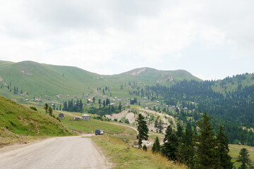 Georgian mountain landscape with a country road, a view of the woodlands