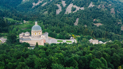 Aerial view of The Sanctuary of Oropa, Roman Catholic building in the Biellese Alps, Northern Italy. Tourist attraction and famous place of pilgrimage in Piedmont. Drone photography.