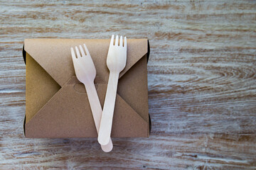 Eco friendly paper dishes, box and wooden forks. Recyclable tableware for food delivery.