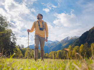 trip to Caucasus mountains, Arkhyz, Teberdinsky reserve. concept of discovery and exploration of wild places in early autumn. Man hiking in mountains with backpack and photo camera