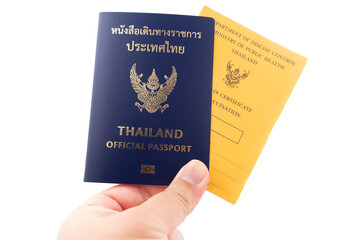 Hand holding Thailand official passport and vaccine passport are on isolated white background with a clipping path.