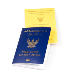 Thailand official passport and vaccine passport on the isolated white background. Certificate of vaccination for travel during coronavirus outbreak.