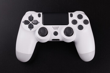 White video game controller, joystick for game console isolated on black background. Gamer control...