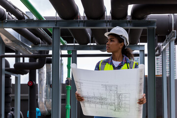 Engineers with draft plan of building on constructing site. Engineer working on building site....